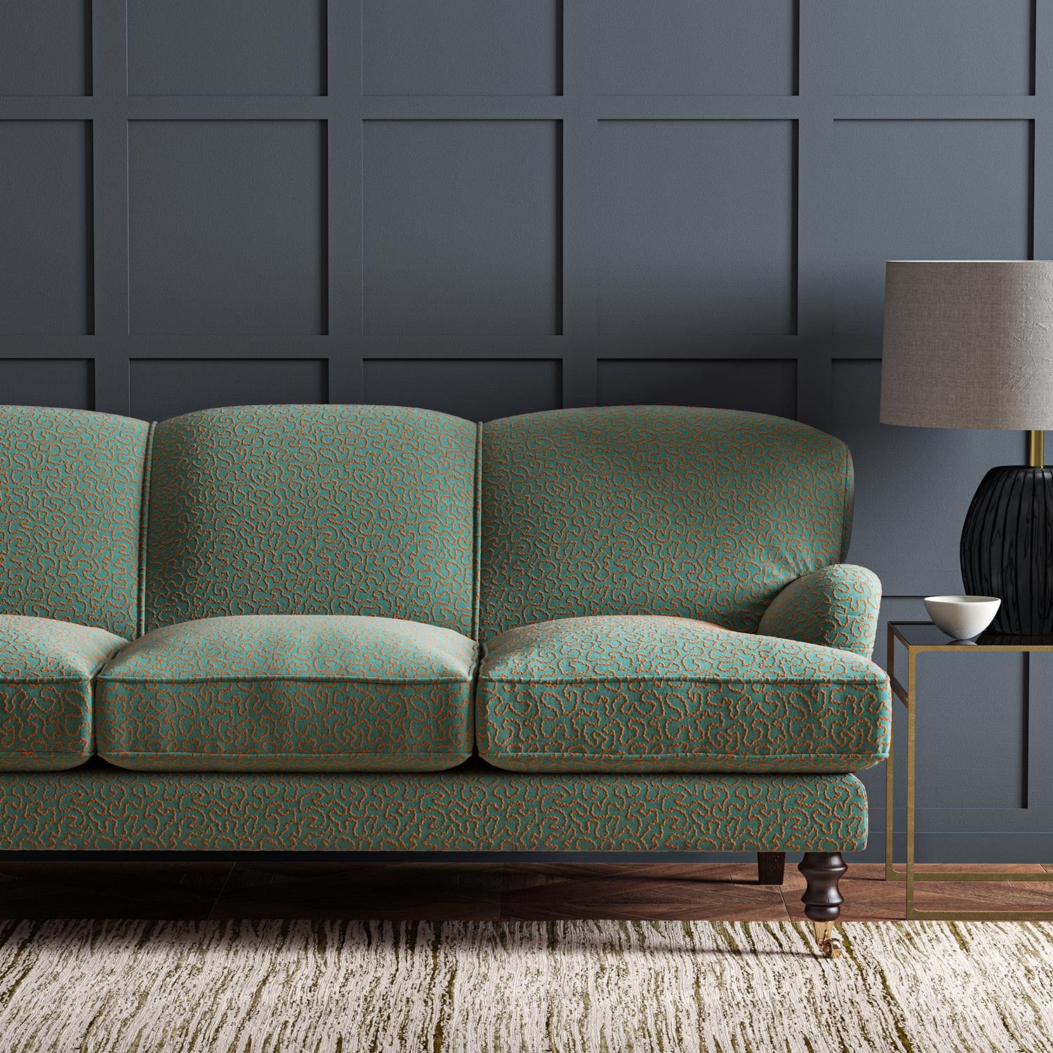 Sofa upholstered in a blue and orange woven fabric featuring a wavy pattern.