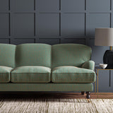 Sofa upholstered in a blue and orange woven fabric featuring a wavy pattern.