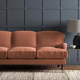 Sofa upholstered in a red and off-white woven fabric featuring a wavy pattern.