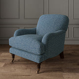 Chair upholstered in a blue and off-white woven fabric featuring a wavy pattern.