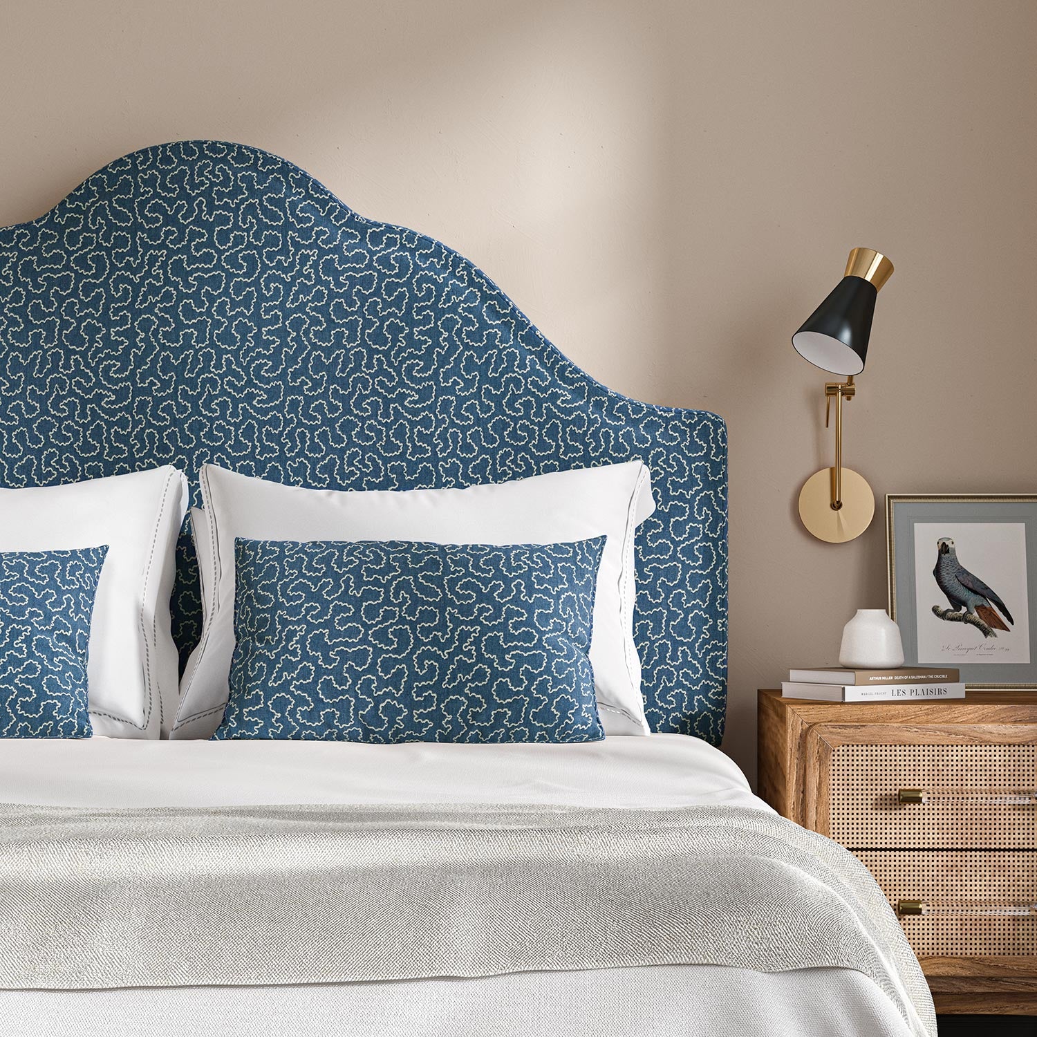 Headboard upholstered in a blue and off-white woven fabric featuring a wavy pattern.