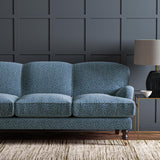 Sofa upholstered in a blue and off-white woven fabric featuring a wavy pattern.