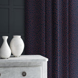 Curtain in blue and red woven fabric featuring a wavy pattern.