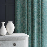 Curtain in blue and off-white woven fabric featuring a wavy pattern.