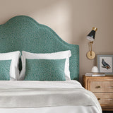 Headboard upholstered in a blue and off-white woven fabric featuring a wavy pattern.