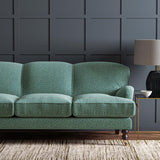 Sofa upholstered in a blue and off-white woven fabric featuring a wavy pattern.