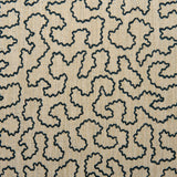A woven fabric sample in black and beige featuring a wavy pattern.