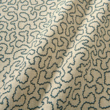 A woven fabric sample in black and beige featuring a wavy pattern.