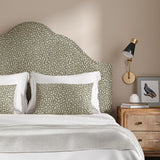 Headboard upholstered in a black and beige woven fabric featuring a wavy pattern.