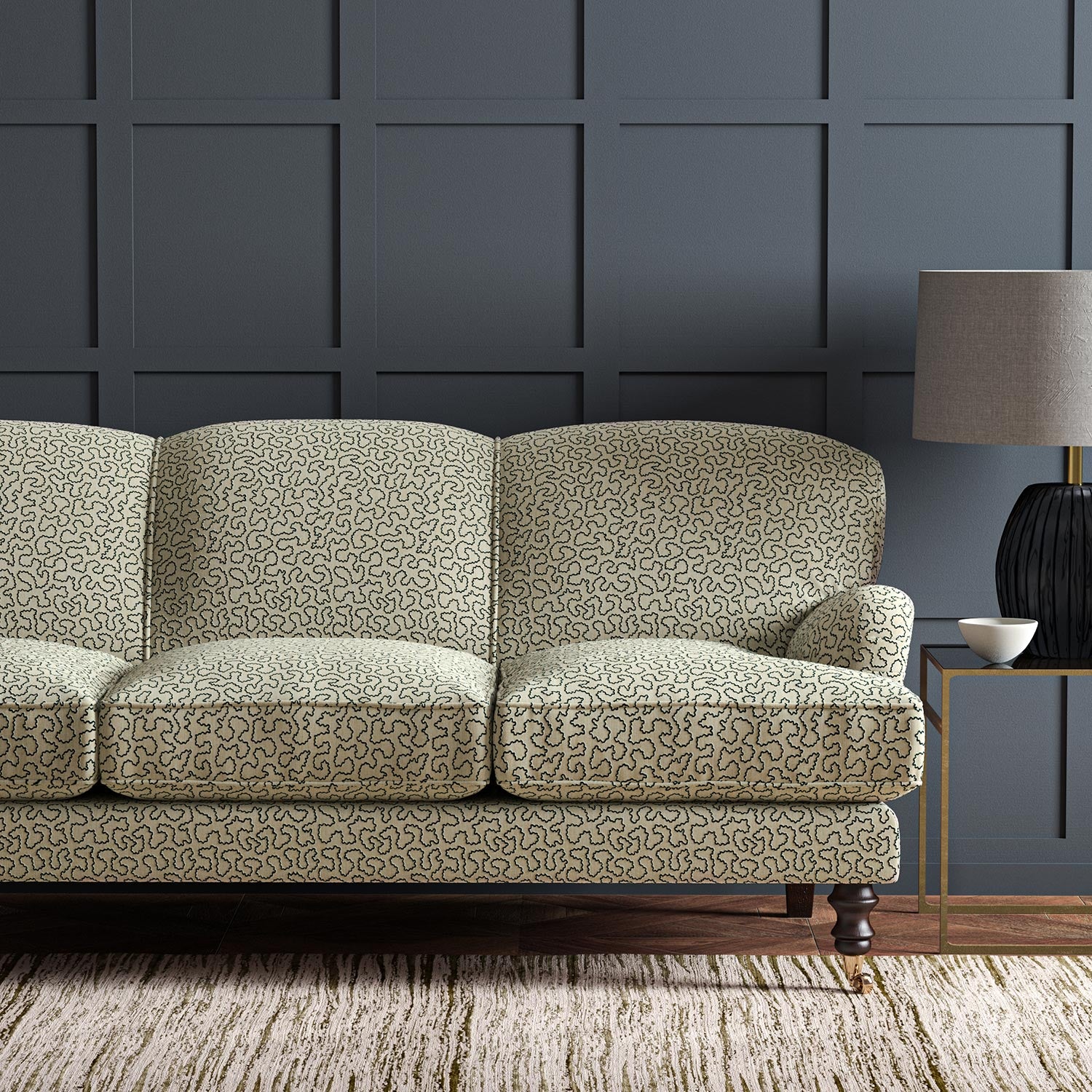 Sofa upholstered in a black and beige woven fabric featuring a wavy pattern.