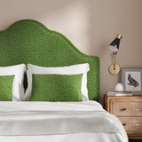 Headboard upholstered in a green woven fabric featuring a wavy pattern.