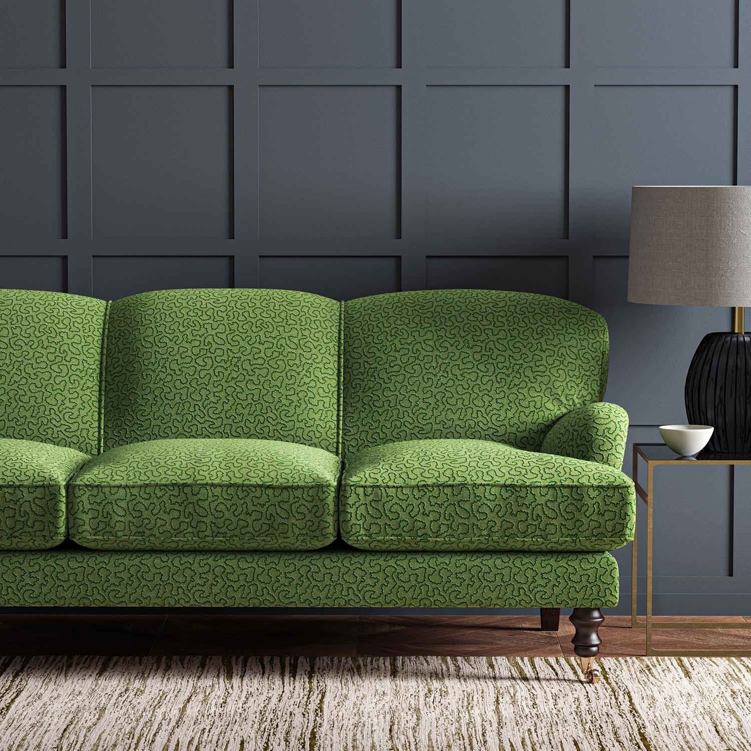 Sofa upholstered in a green woven fabric featuring a wavy pattern.