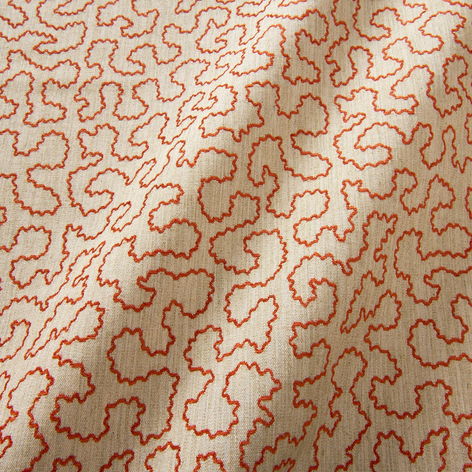 A woven fabric sample in red and beige featuring a wavy pattern.