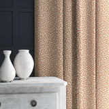 Curtain in red and beige woven fabric featuring a wavy pattern.