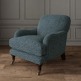 Chair upholstered in a blue and off-white woven fabric featuring a wavy pattern.