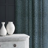 Curtain in blue and off-white woven fabric featuring a wavy pattern.