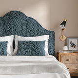 Headboard upholstered in a blue and off-white woven fabric featuring a wavy pattern.