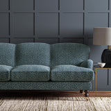 Sofa upholstered in a blue and off-white woven fabric featuring a wavy pattern.