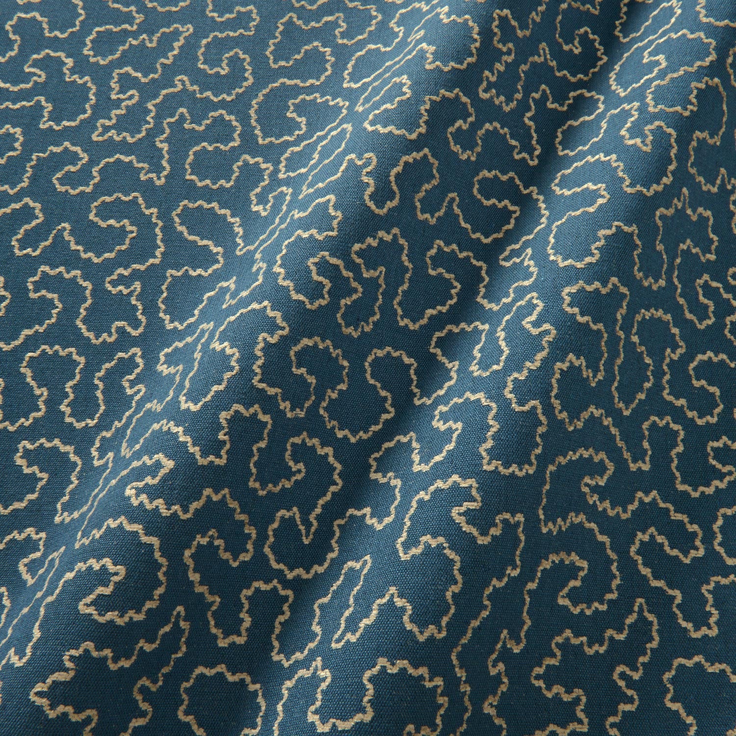 A woven fabric sample in blue and off-white featuring a wavy pattern.
