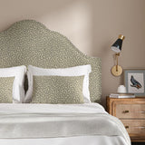 Headboard upholstered in a blue and beige woven fabric featuring a wavy pattern.