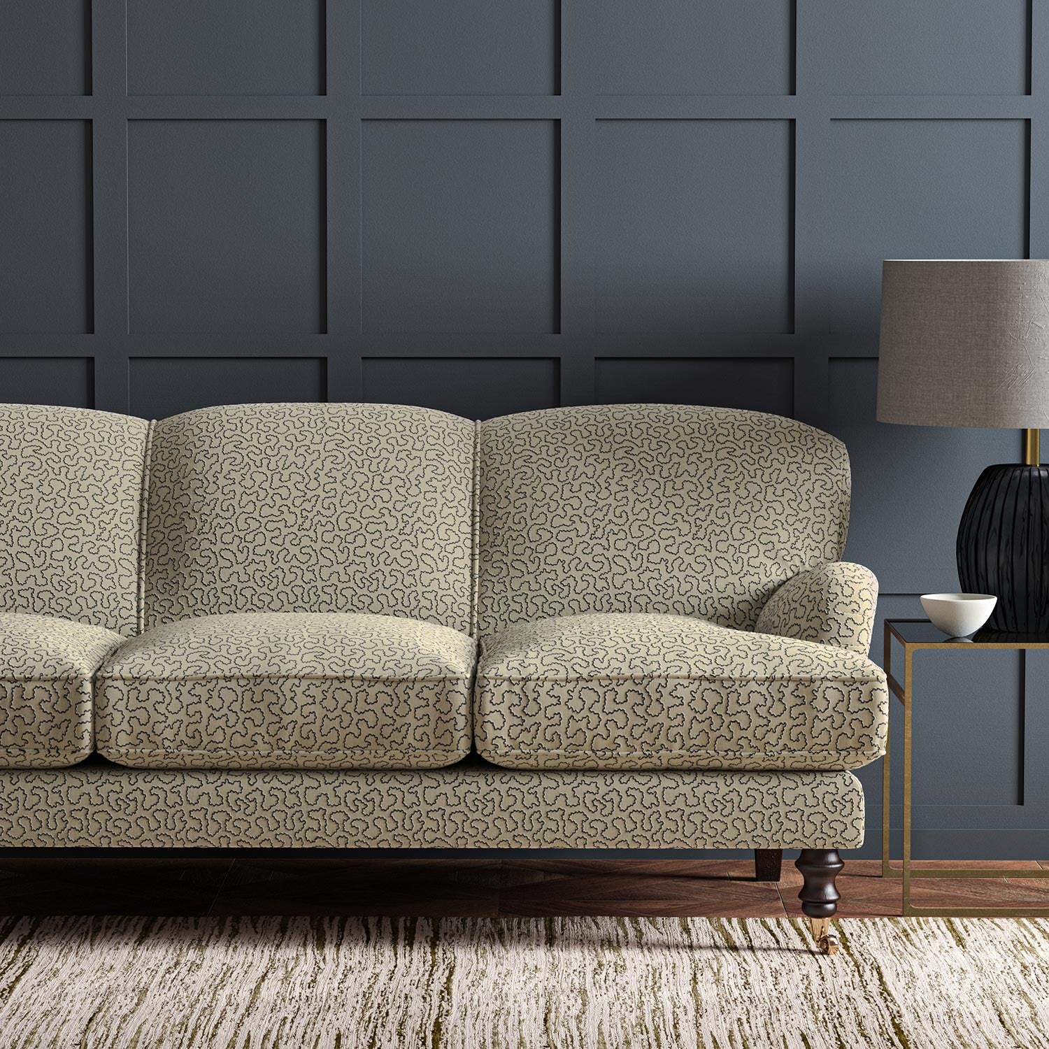 Sofa upholstered in a blue and beige woven fabric featuring a wavy pattern.