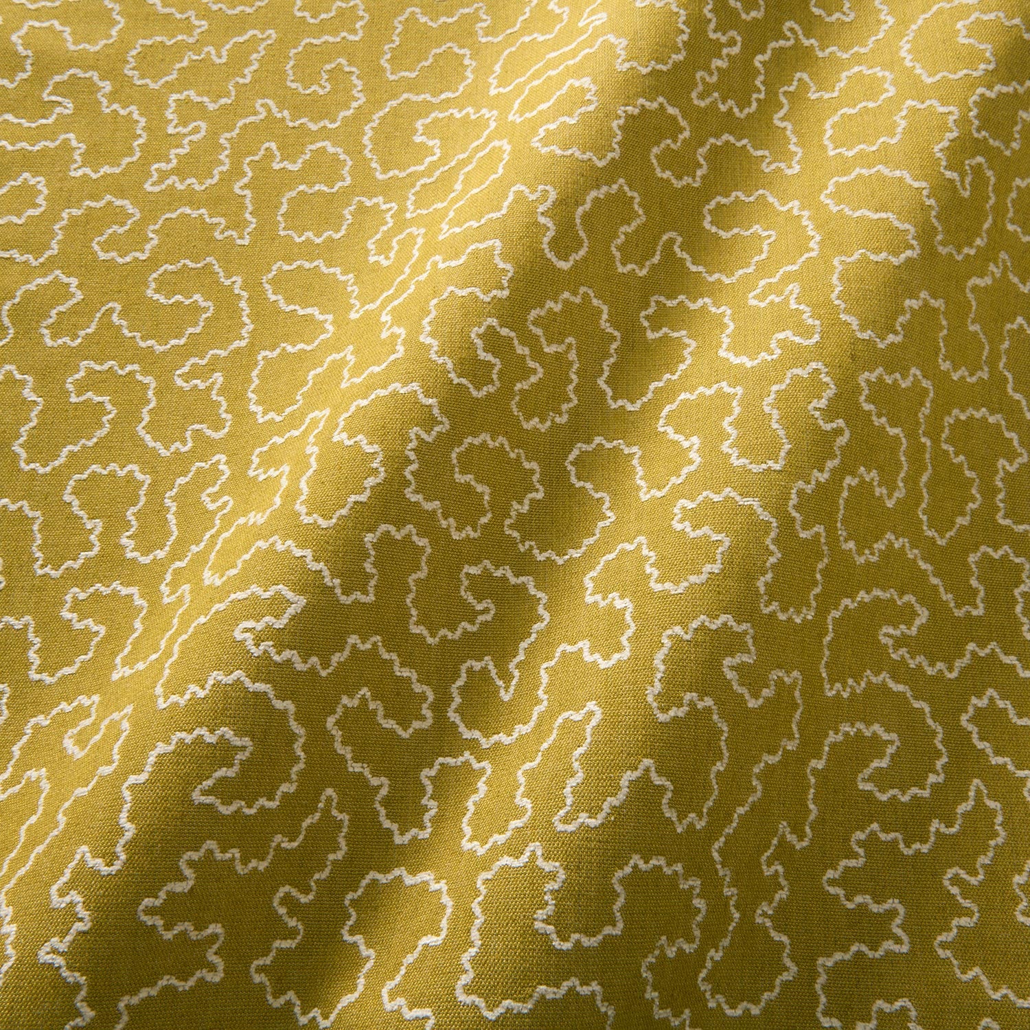 A woven fabric sample in yellow and white featuring a wavy pattern.