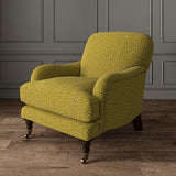 Chair upholstered in a yellow and white woven fabric featuring a wavy pattern.