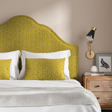 Headboard upholstered in a yellow and white woven fabric featuring a wavy pattern.