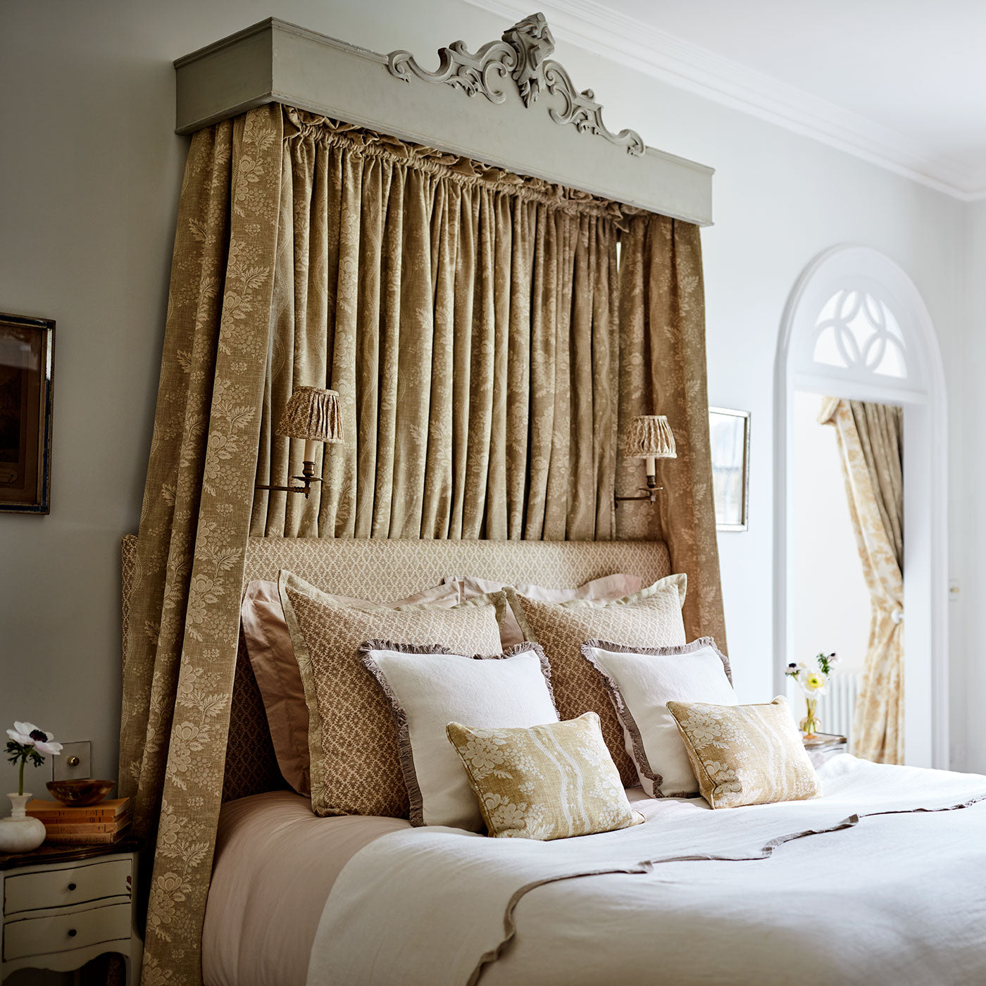 Headboard & cushions upholstered in a yellow and neutral printed linen fabric with a geometric pattern