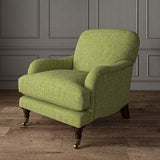 Green chair upholstered in a versatile woven fabric.