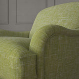 Green chair upholstered in a versatile woven fabric.