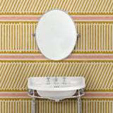 Cloakroom with playful gold and pink wallpaper with a combination of tonal stripes, zigzags, and matching colour bands.