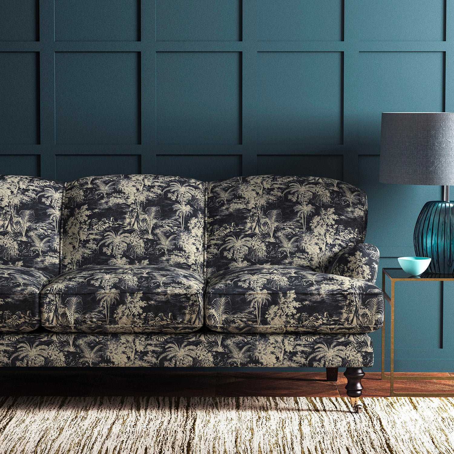 Sofa covered in a printed velvet fabric featuring a rich, tropical-style toile in slate.
