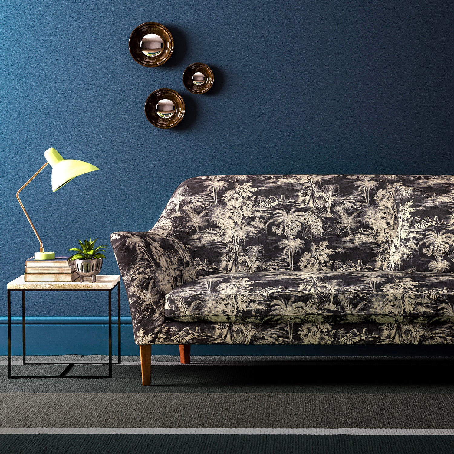 Sofa covered in a printed velvet fabric featuring a rich, tropical-style toile in slate.