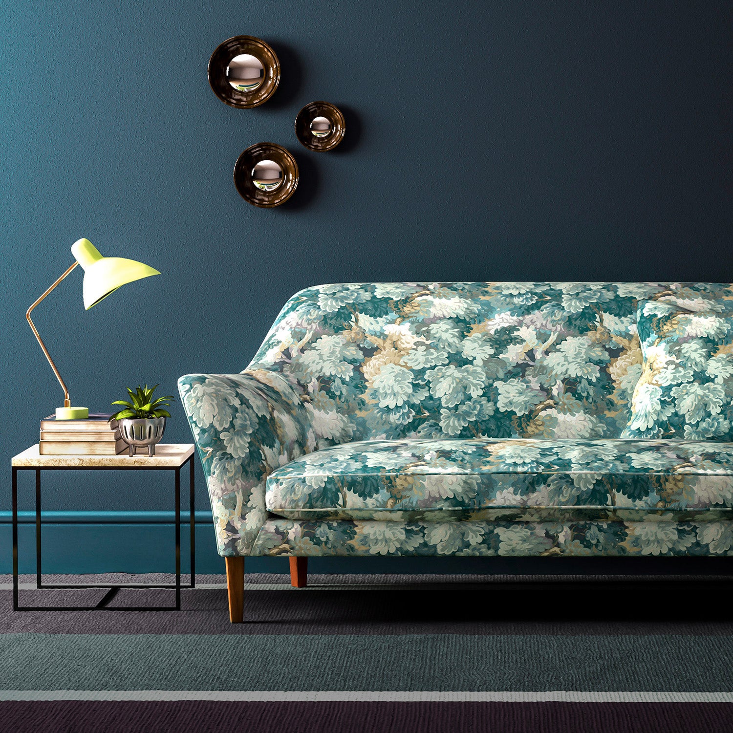 Sofa covered in a printed velvet fabric featuring a classic oak leaf design in teal.
