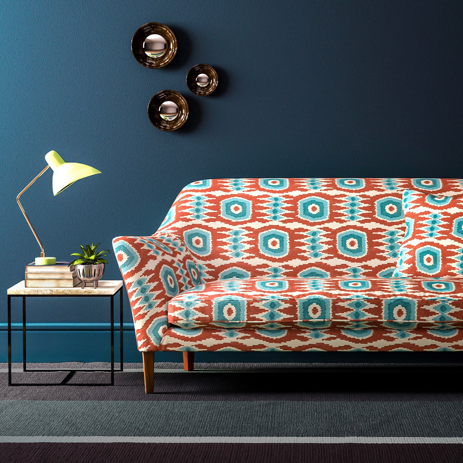 Velvet sofa upholstered in a orange and blue velvet upholstery fabric with abstract print and stain resistant finish