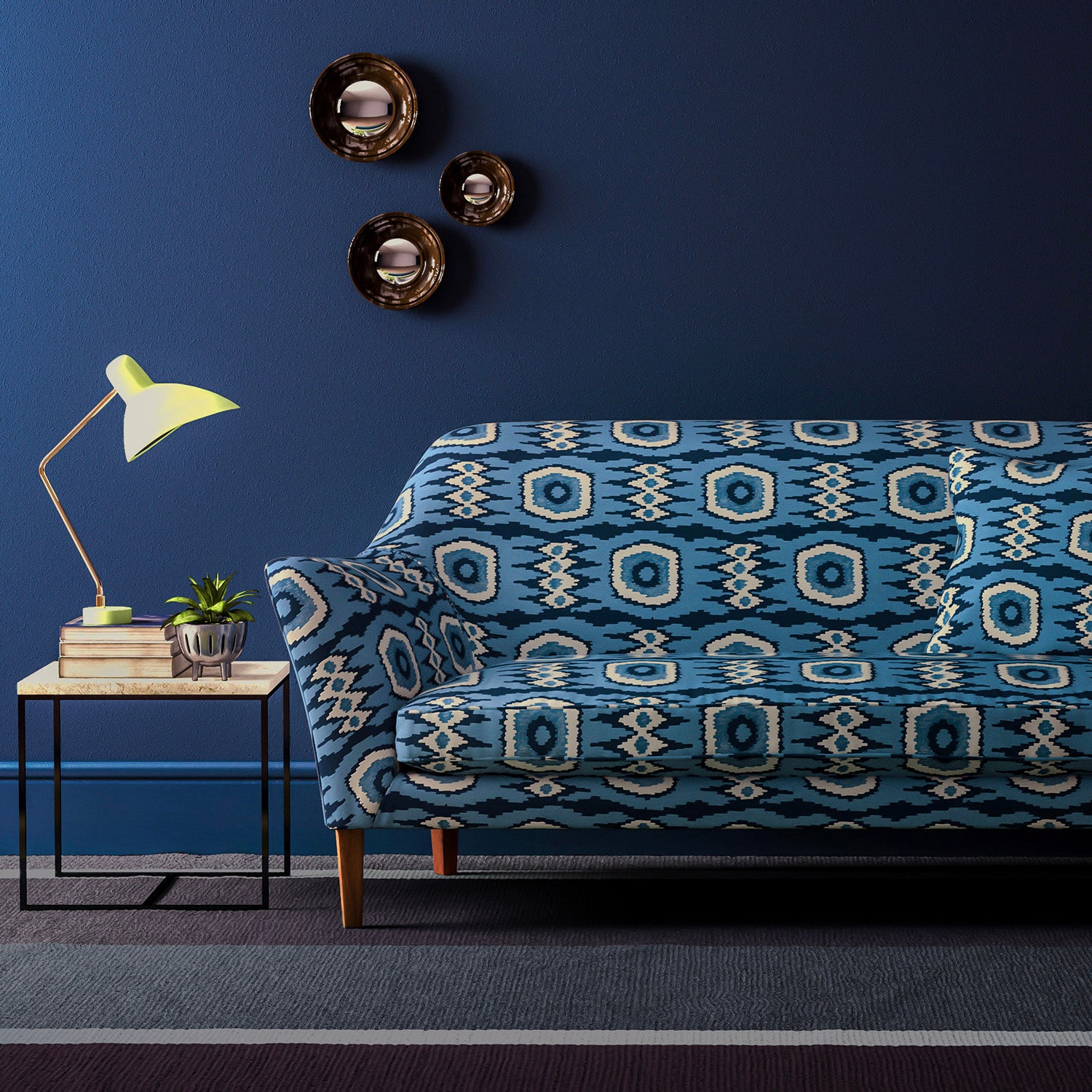 Sofa covered in a printed velvet upholstery fabric featuring a fun, jazzy pattern in navy.