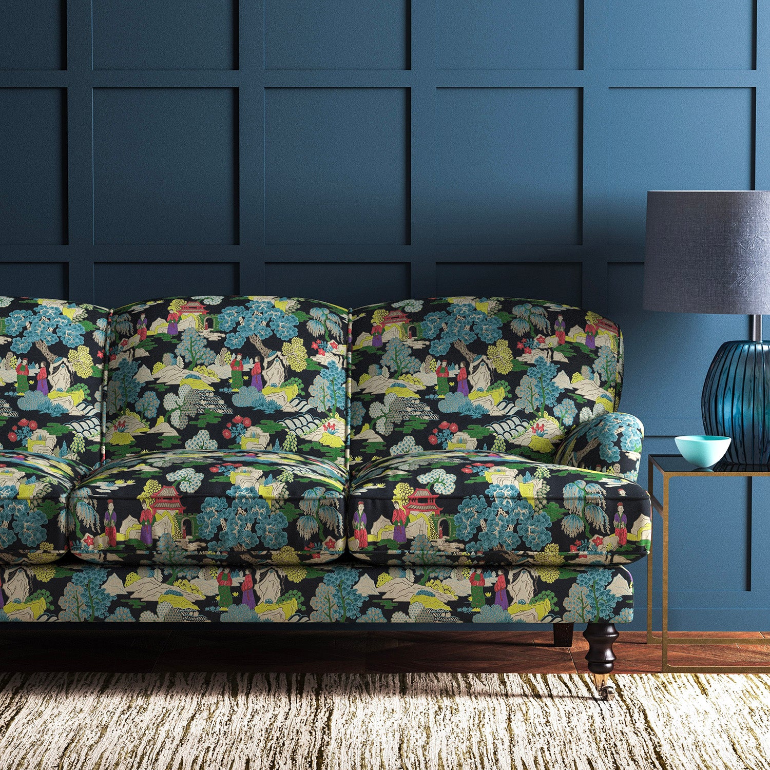 Sofa covered in a printed velvet fabric featuring a Japanese-style toile in blue and yellow.