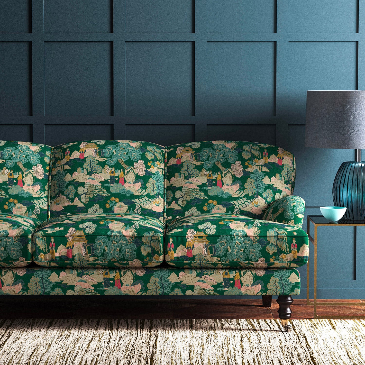 Sofa covered in a printed velvet fabric featuring a Japanese-style toile in green.