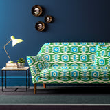 Sofa covered in a printed velvet upholstery fabric featuring a fun, jazzy pattern in Seagreen.