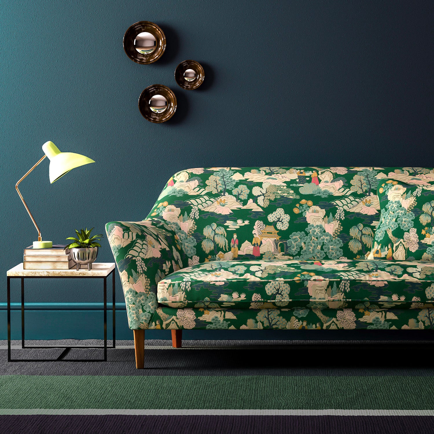 Sofa covered in a printed velvet fabric featuring a Japanese-style toile in green.