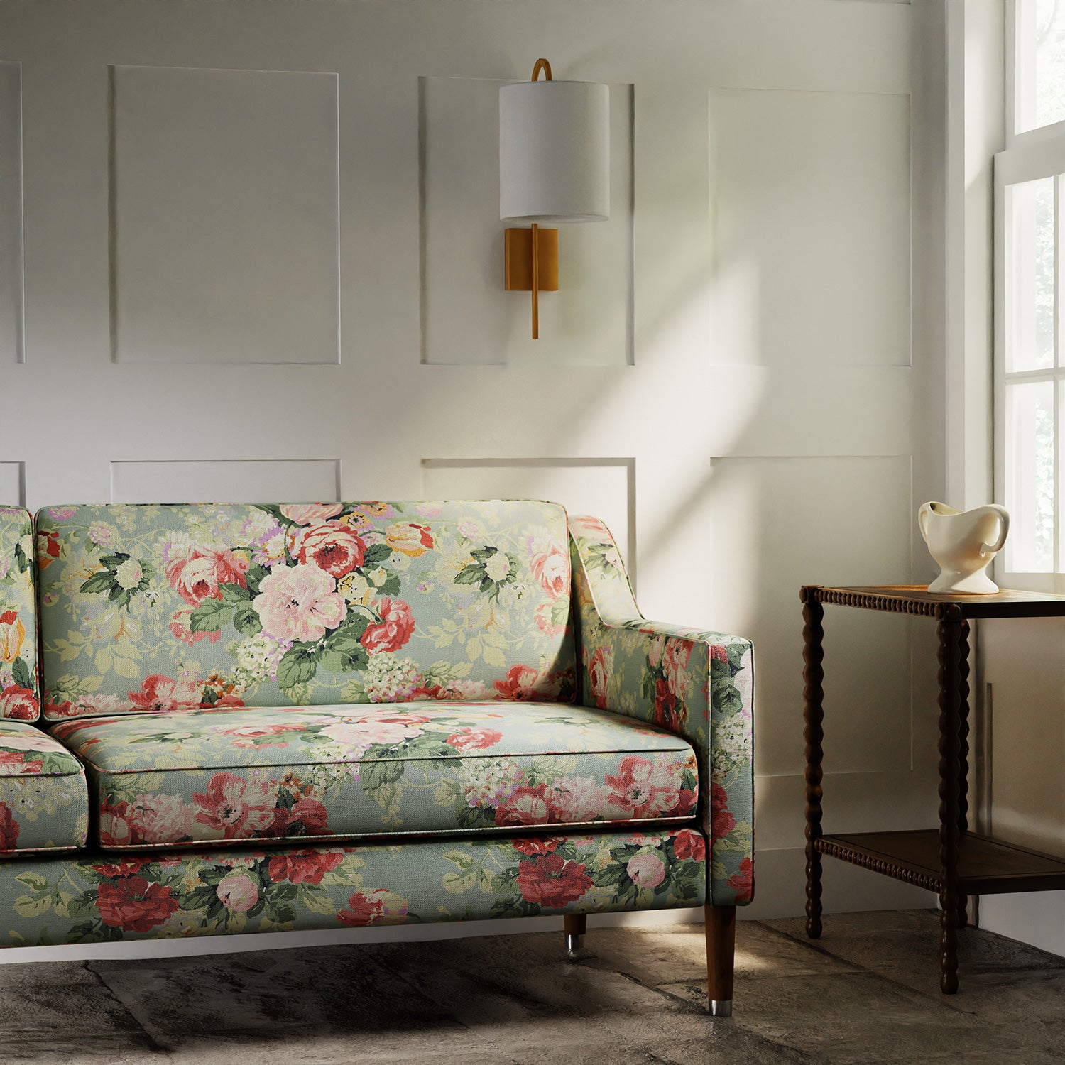 Sofa covered in a printed linen fabric showcasing bouquets of pink and red roses.