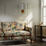Sofa in a printed linen fabric with bouquets of roses on a tea-stained background.