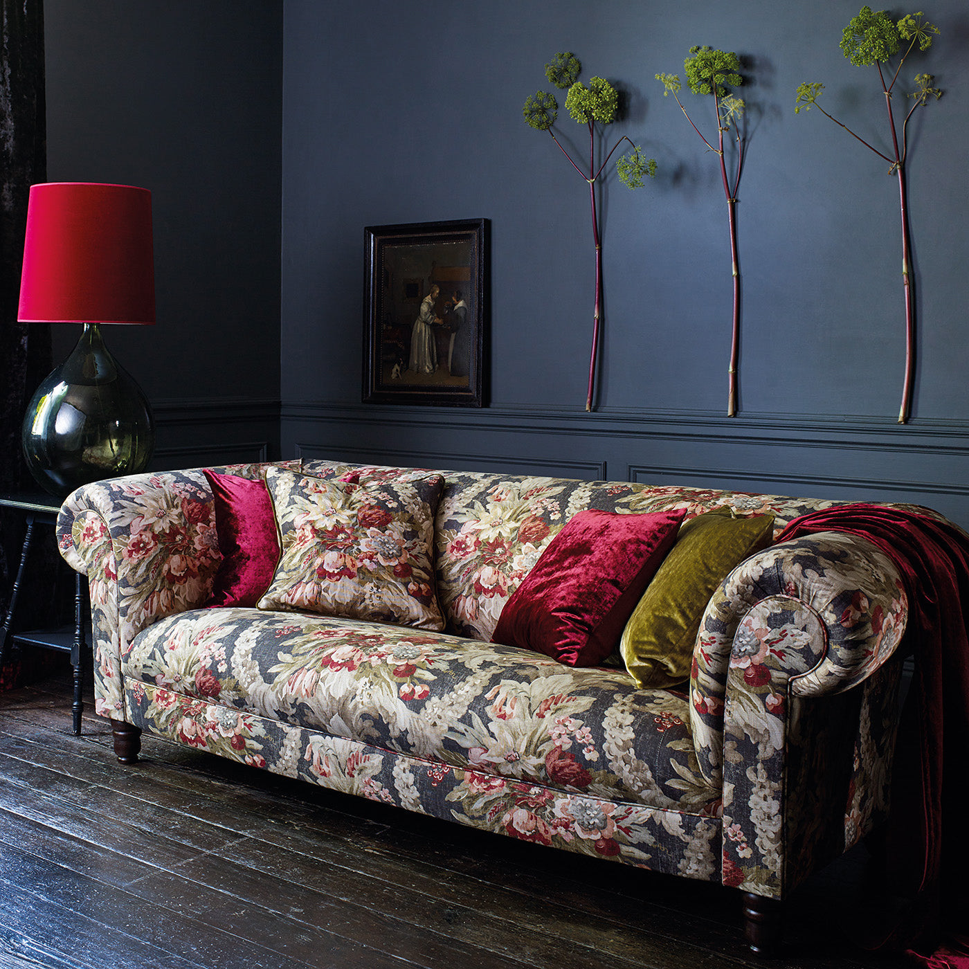 Sofa upholstered in a luxury dark blue and pink floral bouquet fabric
