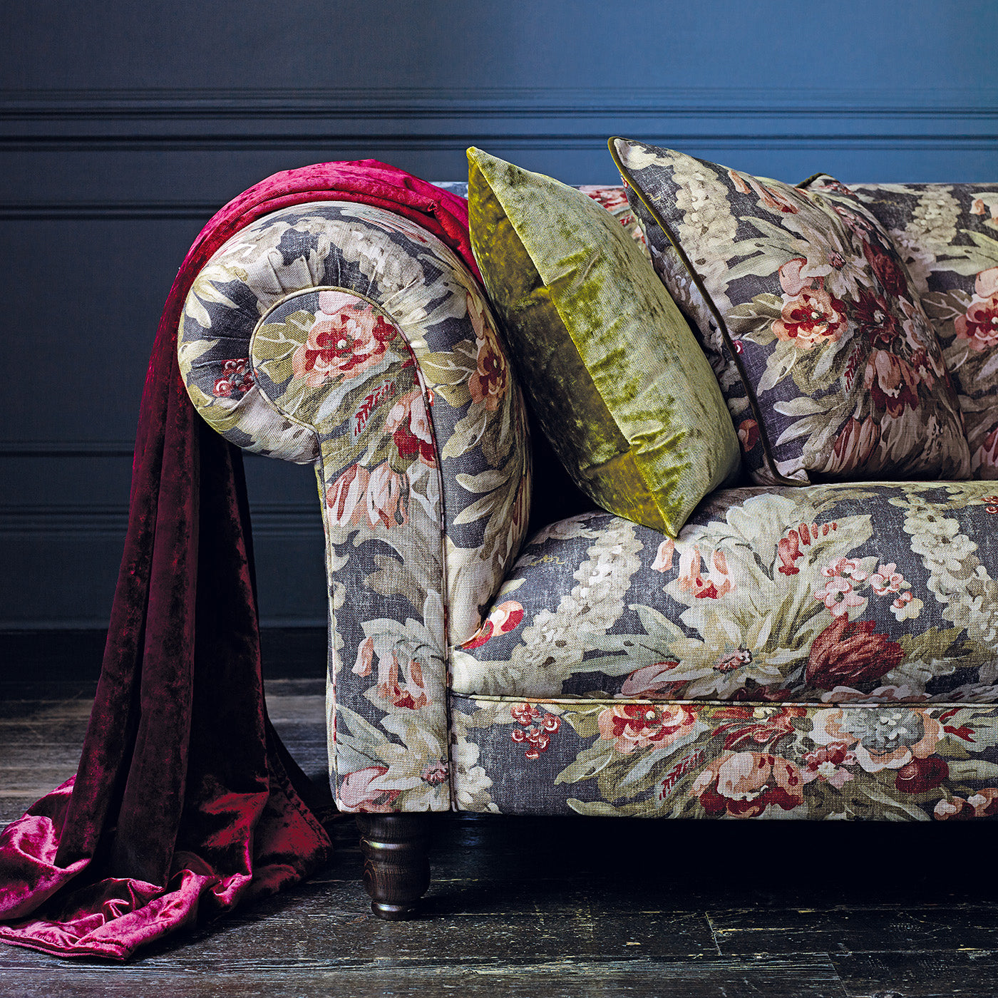 Sofa upholstered in a luxury dark blue and pink floral bouquet fabric