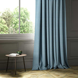 A blue woven fabric shown as a curtain.