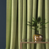 Curtain in a lime green herringbone wool fabric