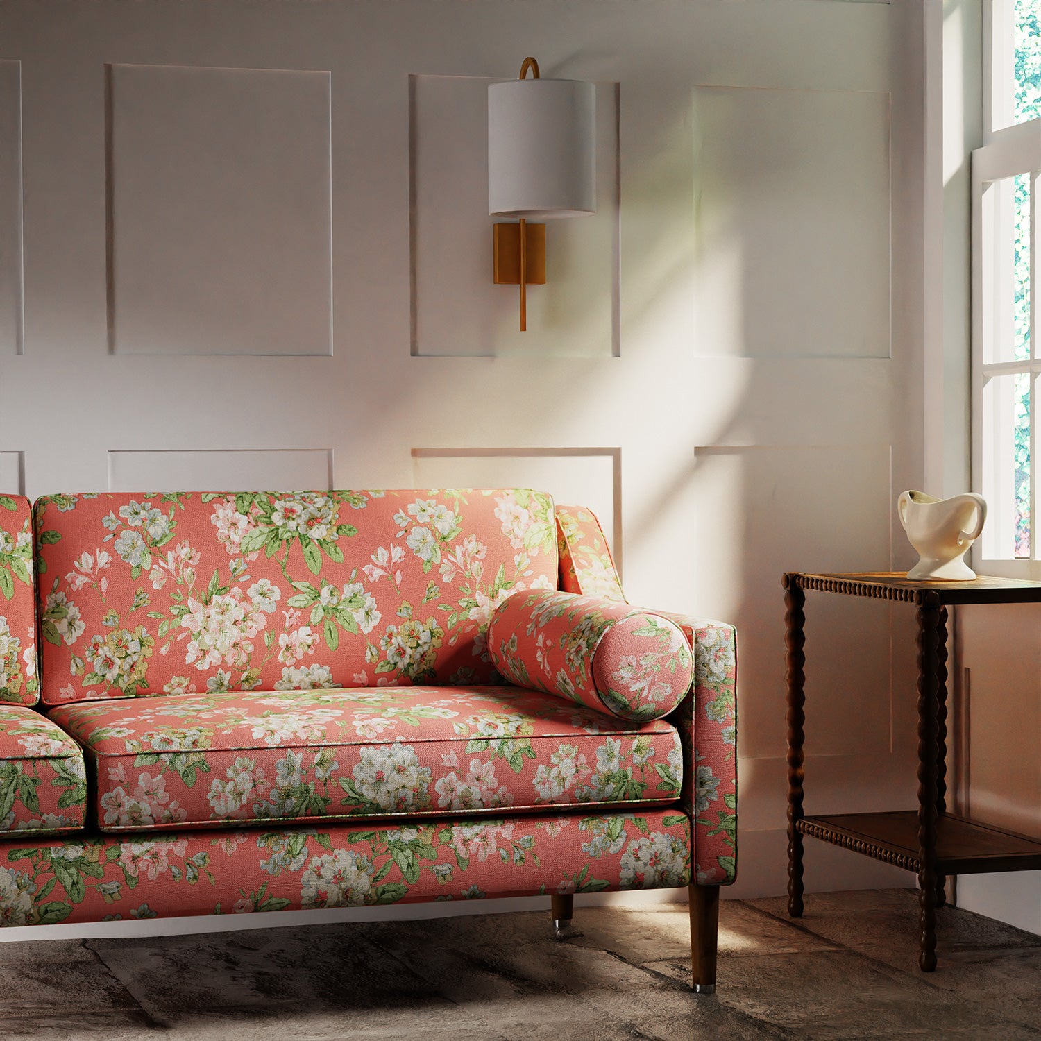 Sofa in a printed linen fabric with floral pattern in pink, green and white colours.