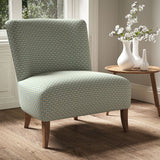 Armchair in a printed linen fabric with textural weave pattern in blue and yellow colours.