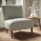 Armchair in a printed linen fabric with textural weave pattern in brown and blue colours.